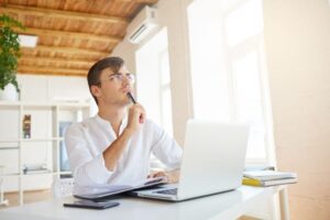 a man thinking on his office desk